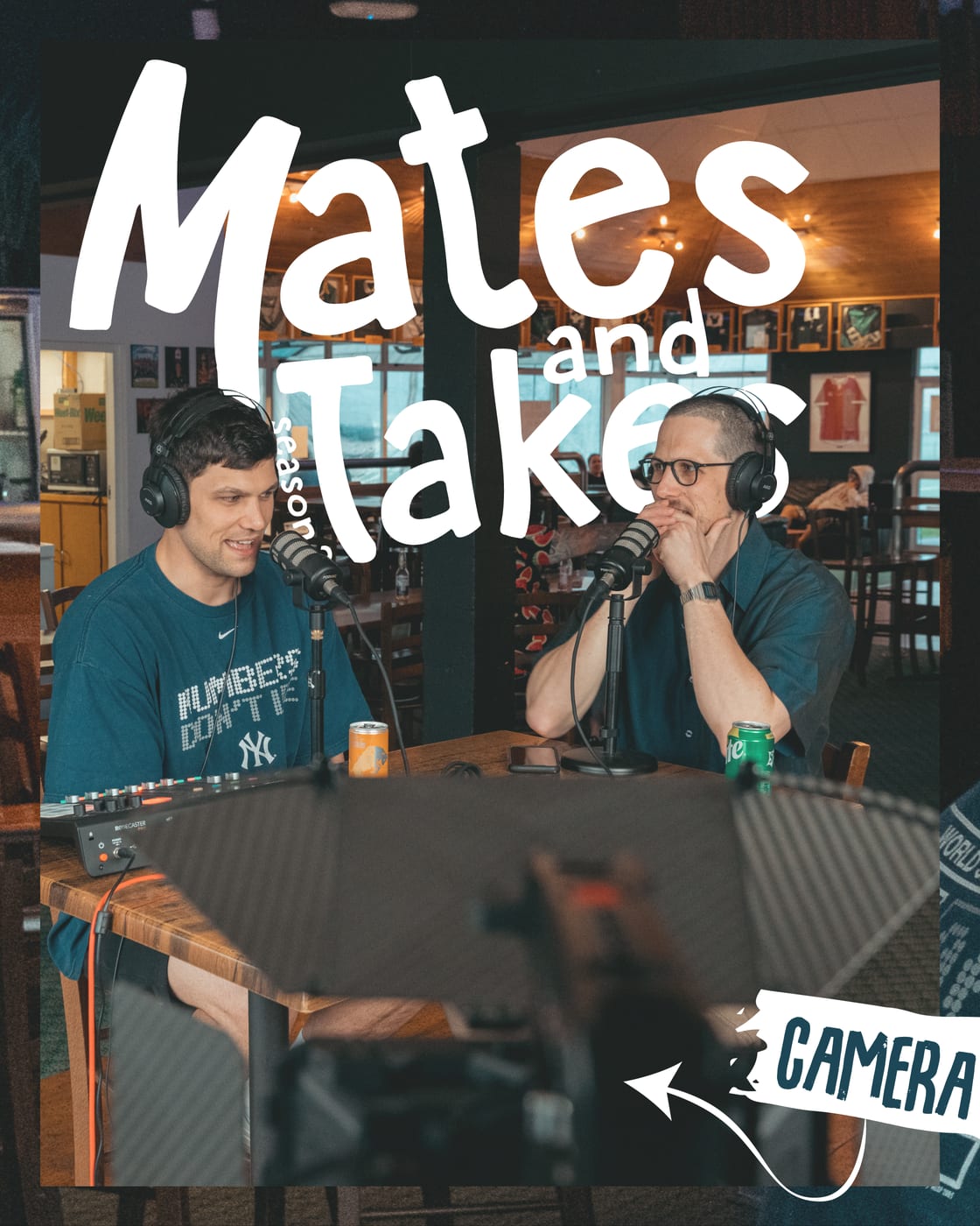 The live episode wide shot: the whole table mid-take, the camera guy labelled in the corner