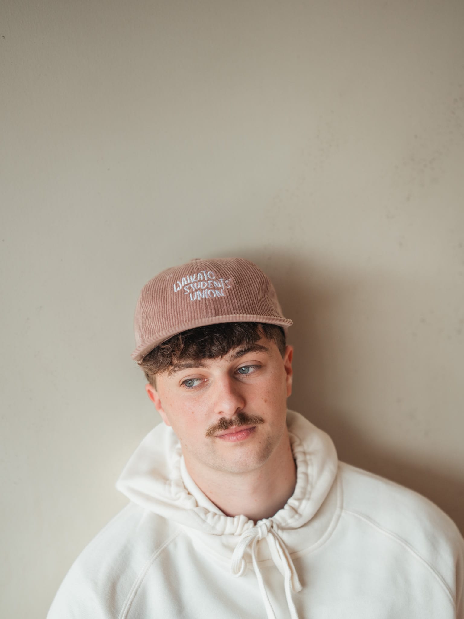 Seamus in the pink corduroy cap, glancing sideways