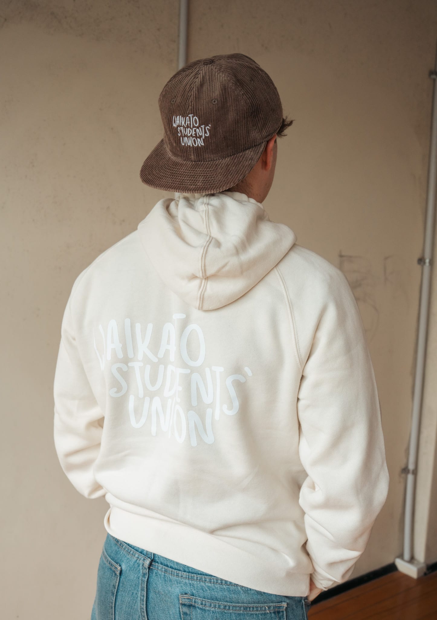 The back of the cream hoodie with the hand-lettered union print